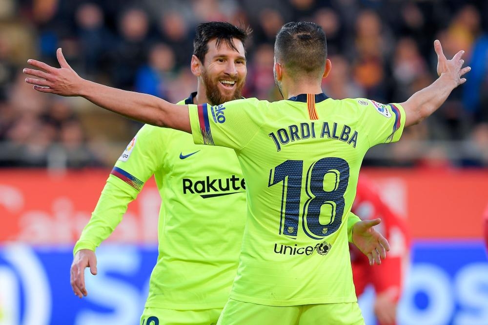 Barcelona's forward Lionel Messi (L) celebrates with defender Jordi Alba after scoring a goal during the Spanish league football match against Girona FC at the Montilivi Stadium in Girona Sunday. — AFP