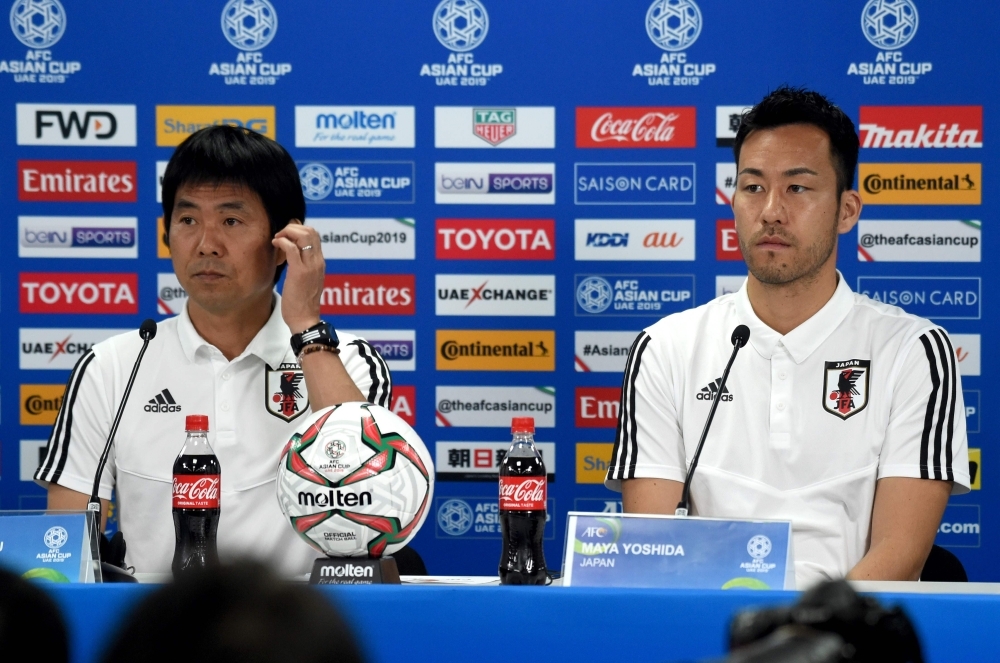 Japan's player Maya Yoshida (R) with head coach Hajime Moriyasu (L) attend the pre-match press conference ahead of the AFC Asian Cup final match against Qatar at the Zayed Sports City Stadium in Abu Dhabi on Thursday. — AFP