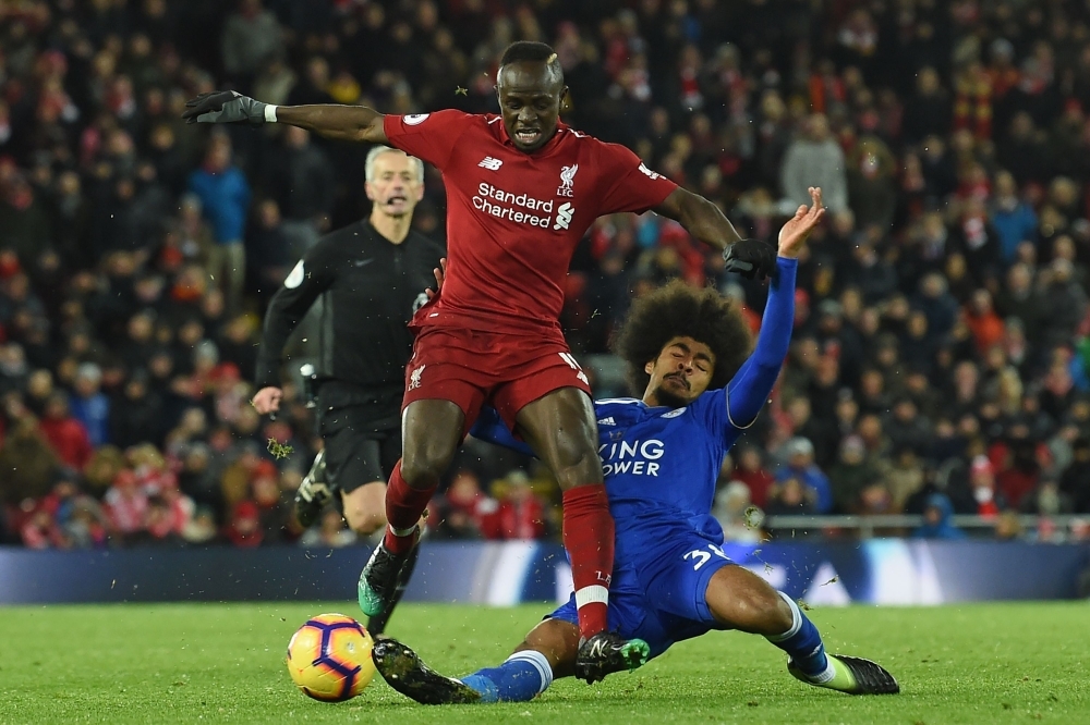 Liverpool's Senegalese striker Sadio Mane (L) is tackled by Leicester City's English midfielder Hamza Choudhury (R) during the English Premier League football match between Liverpool and Leicester City at Anfield in Liverpool, north west England on Wednesday. — AFP