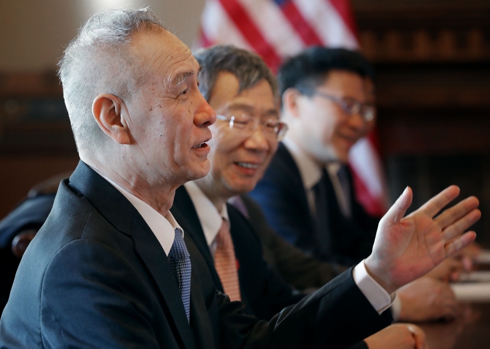 In this recent photo, Chinese Vice Premier Liu He (L), Central Bank Governor Yi Gang (2nd L) and other Chinese vice ministers and senior officials sit down with Trump Administration officials for negotiations in the Diplomatic Room at the Eisenhower Executive Office Building in Washington, DC.  — AFP