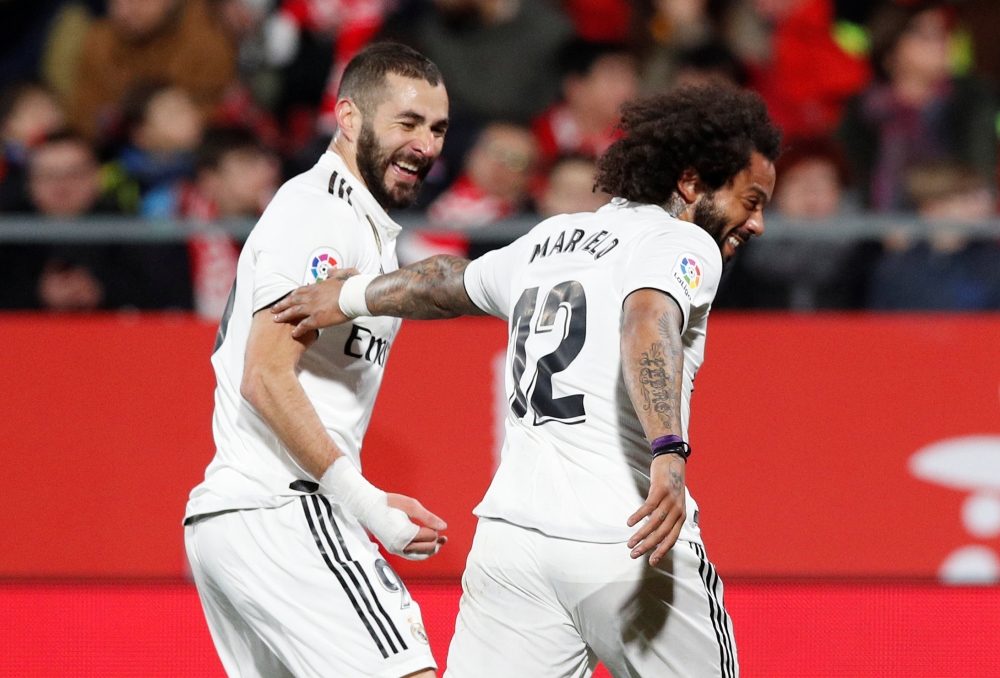 Real Madrid's Karim Benzema celebrates with Marcelo after scoring their first goal against Girona in the Copa del Rey quarterfinal at Montilivi, Girona, Spain, on Thursday. — Reuters