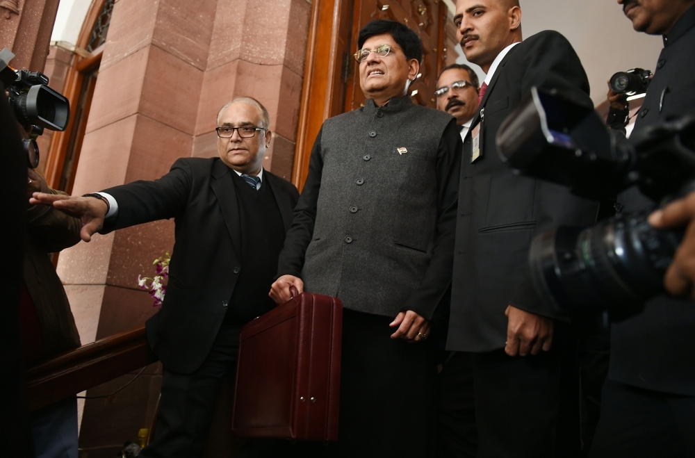 Indian Finance Minister Piyush Goyal (C) arrives at parliament to present the budget in New Delhi on Friday. — AFP