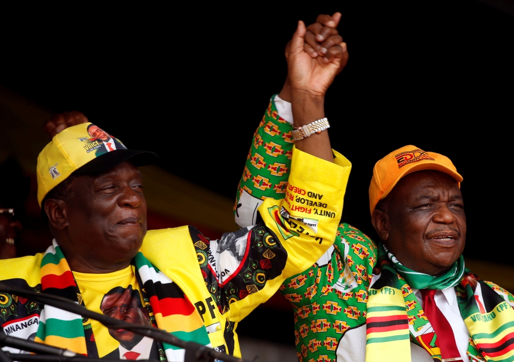 President Emmerson Mnangagwa, left, and his deputy Constantino Chiwenga greet supporters of his ZANU PF party at a rally in Murombedzi, Zimbabwe, in this Nov. 24, 2018 file photo. — Reuters