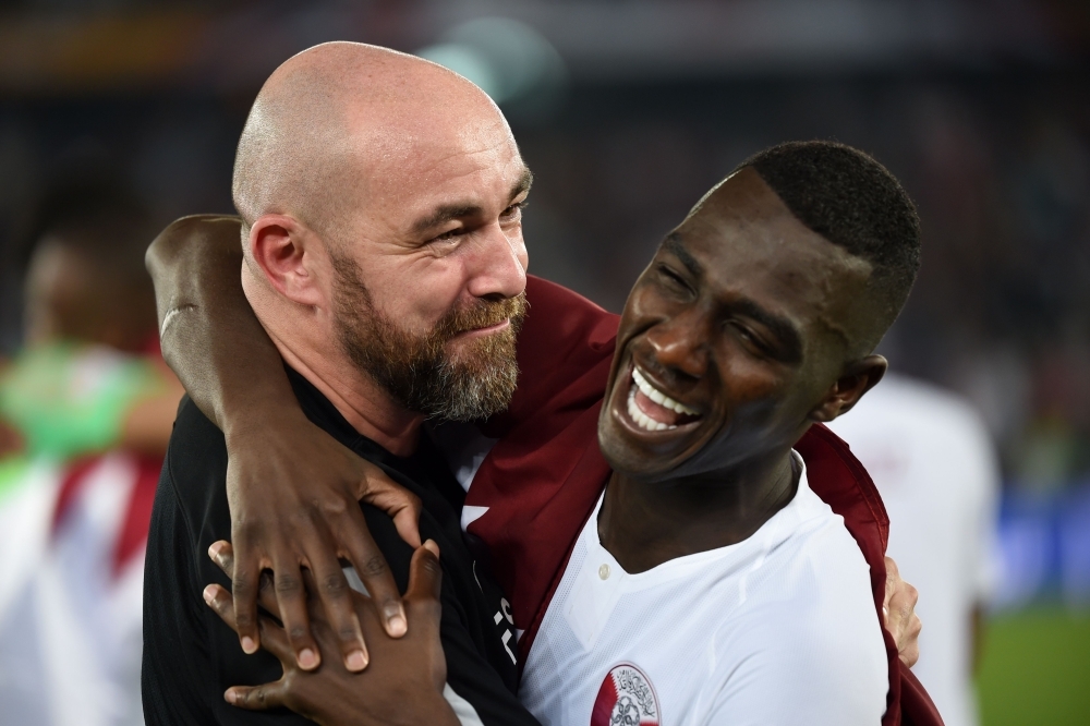 Qatar’s forward Almoez Ali, right, celebrates with Qatar’s coach Felix Sanchez after winning the 2019 AFC Asian Cup final at the Mohammed Bin Zayed Stadium in Abu Dhabi on Friday. — AFP