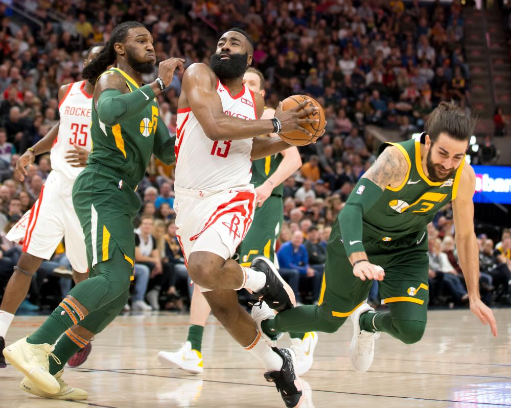 Utah Jazz’s guard Ricky Rubio (R) and Houston Rockets guard James Harden (C) get their feet tanged during their NBA game at Vivint Smart Home Arena in Salt Lake City Saturday. — Reuters 