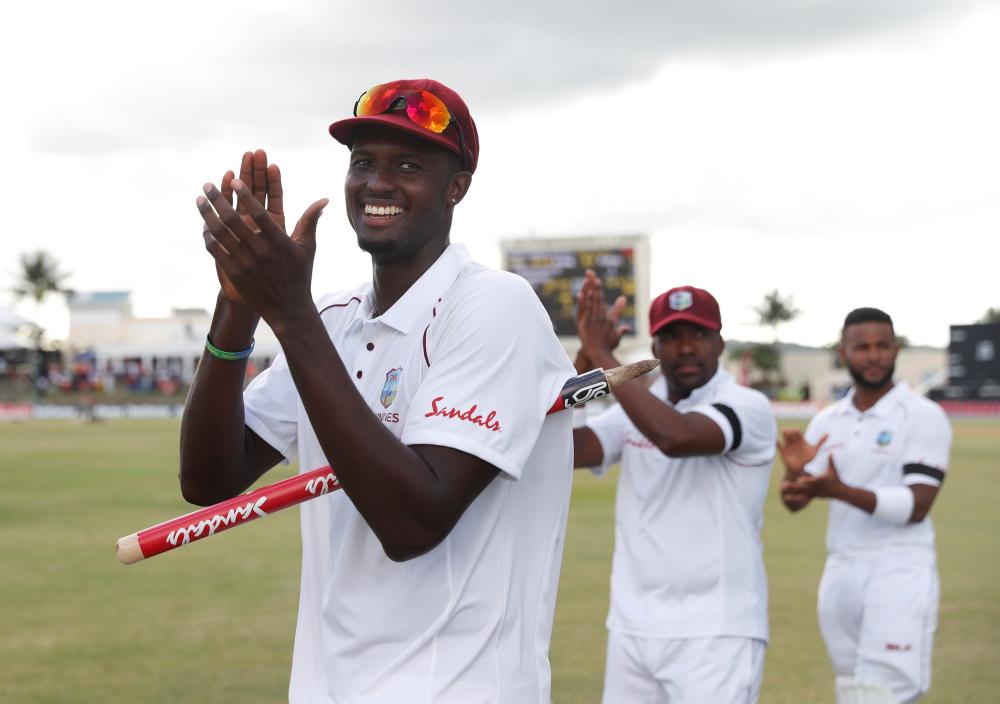 West Indies’ Jason Holder and teammates celebrate winning the Test against England at Sir Vivian Richards Stadium, North Sound, Antigua and Barbuda, Saturday. — Reuters