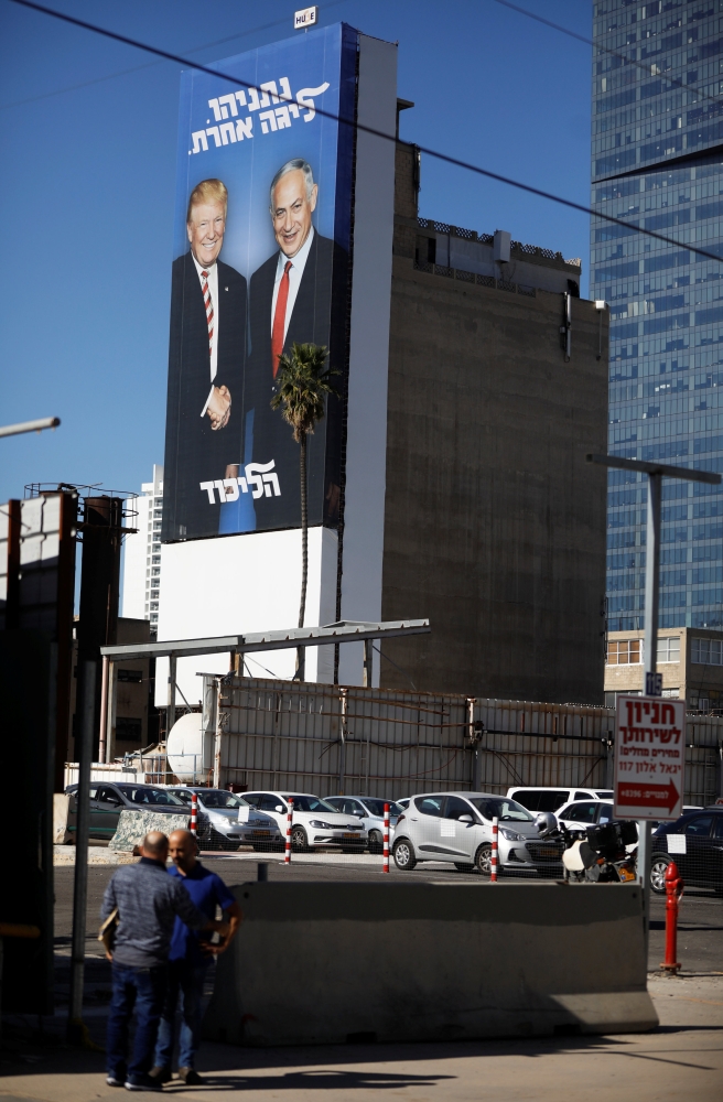 A Likud election campaign billboard, depicting US President Donald Trump shaking hands with Israeli Prime Minister Benjamin Netanyahu, is seen at a main entrance to Tel Aviv, Sunday. — Reuters