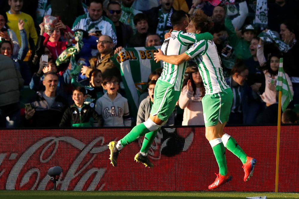 Real Betis' Sergio Canales celebrates scoring against Atletico Madrid during their Spanish League match at Estadio Benito Villamarin, Seville, Sunday. — Reuters