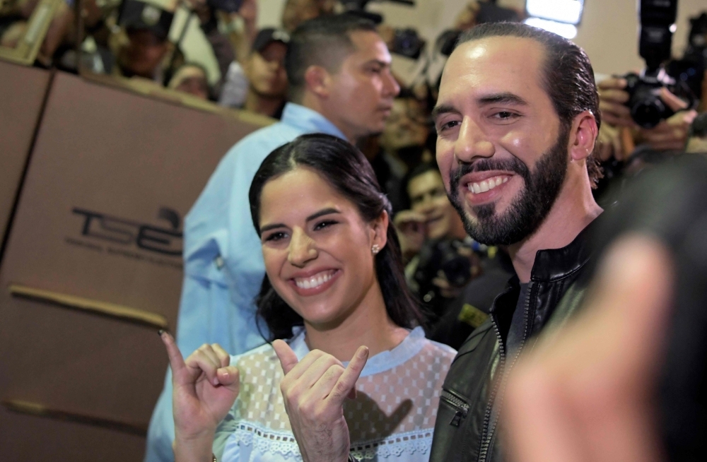 Salvadorean presidential candidate Nayib Bukele (R), of the Great National Alliance (GANA), and his wife Gabriela Rodriguez, pose after voting during the Salvadorean presidential election at a polling station in San Salvador, on Sunday. — AFP