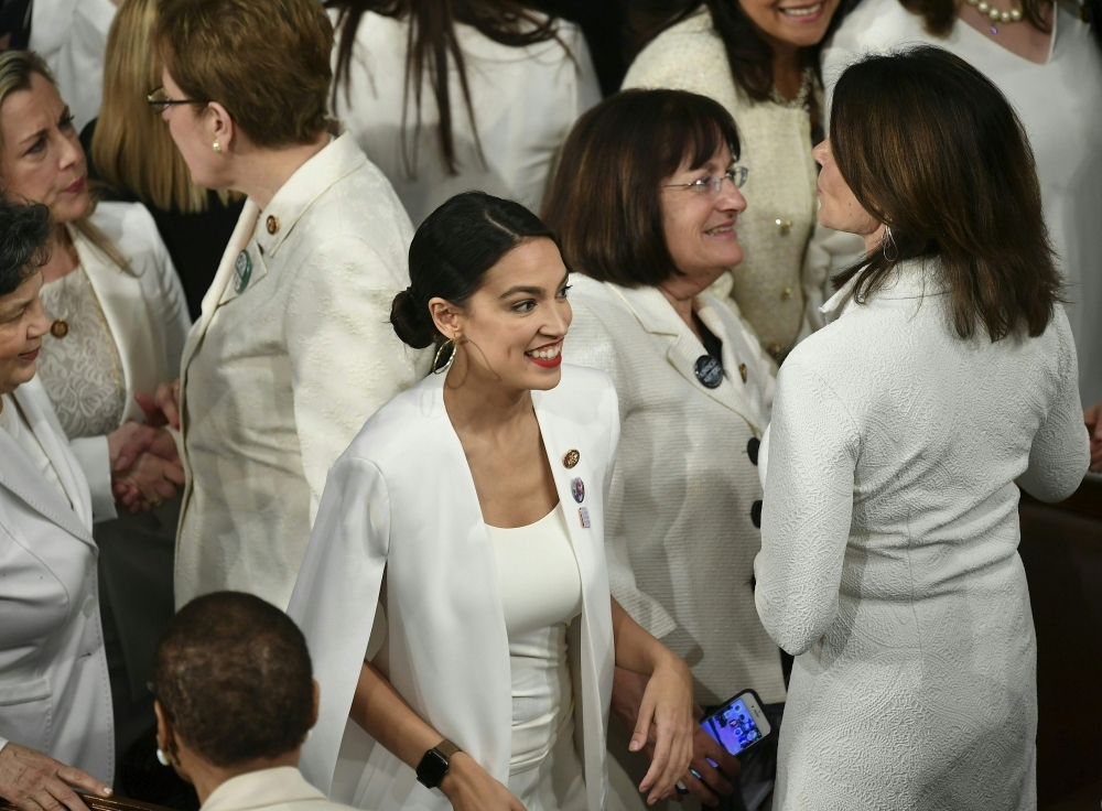 New York Representative Alexandria Octavio-Cortez (C) is seen amidst other Congress women ahead of US President Donald Trump's State of the Union address at the US Capitol in Washington, DC, on Tuesday. Women from both political parties wore white outfits tonight at the behest of the Democratic Women’s Working Group to honor the legacy of women's suffrage in the United States. — AFP
