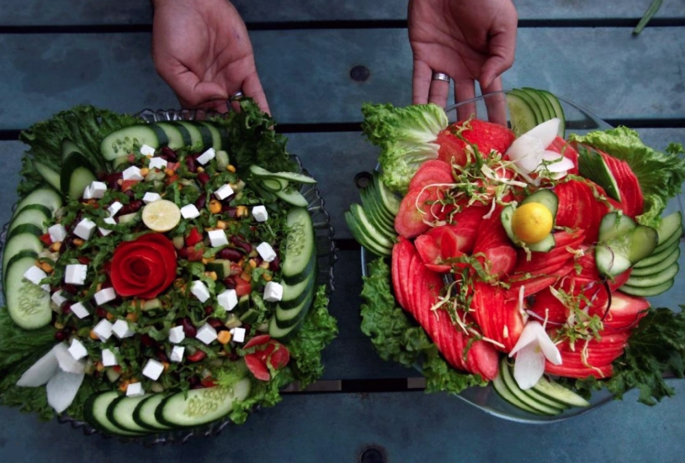 A waiter presents two types of salad served by Habibi restaurant in Peshawar, Pakistan. — Reuters