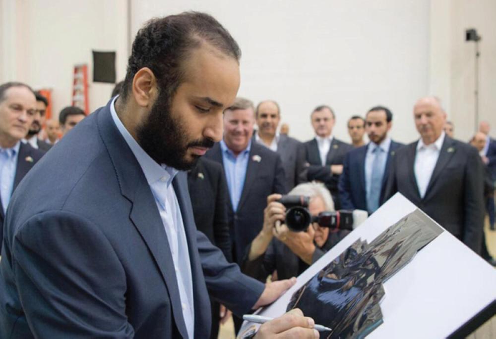 Crown Prince Muhammad Bin Salman, deputy premier and minister of defense, wrote: “High above the clouds” as he signed the last panel installed on the first Saudi telecommunications satellite during his visit to the Lockheed Martin facility at Silicon Valley in San Francisco last April. — SPA file photo