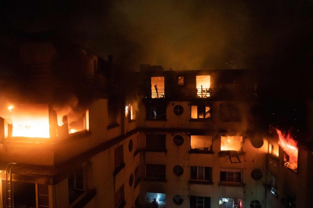 This handout picture taken and released by the Paris firefighters brigade (BSPP) in the night of Tuesday shows a fire in a building in Erlanger street in the 16th arrondissement in Paris. — AFP