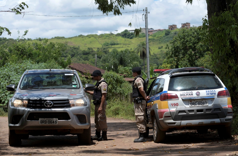 Police officers block a road close to the area of the Gongo Soco mine operated by Vale SA that was evacuated, in Barao de Cocais, Brazil on Friday. — Reuters