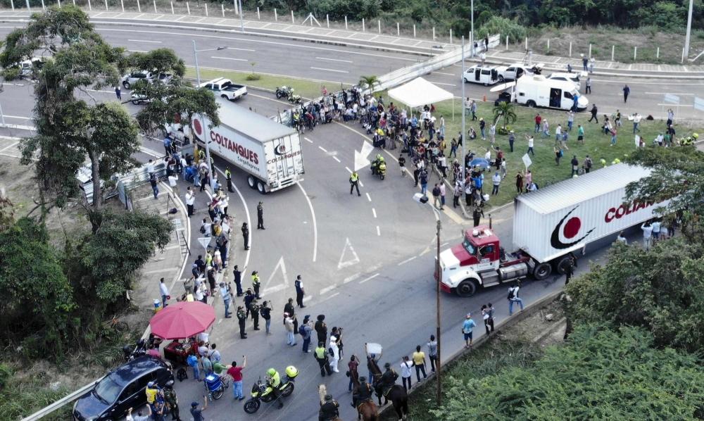 Aerial view of trucks loaded with humanitarian aid for Venezuela drive to the Tienditas Bridge on the border between Cucuta, Colombia and Tachira, Venezuela, on Thursday.  Venezuelan military officers blocked a bridge on the border with Colombia ahead of an anticipated humanitarian aid shipment, as opposition leader Juan Guaido stepped up his challenge to President Nicolas Maduro's authority. — AFP 