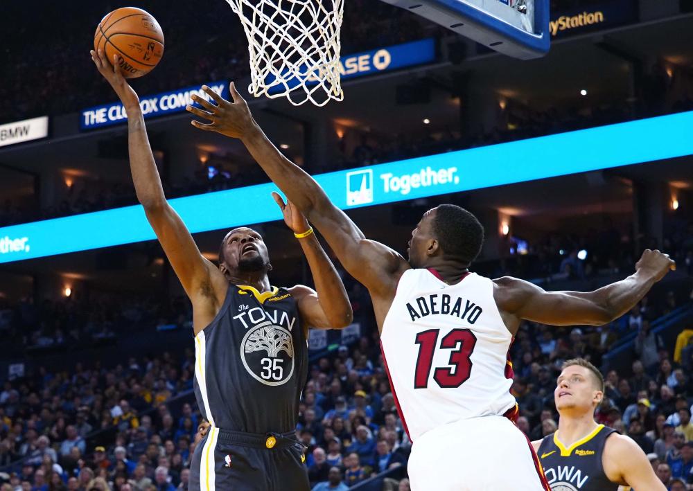 Golden State Warriors’ forward Kevin Durant shoots the ball against Miami Heat’s center Bam Adebayo during their NBA game at Oracle Arena in Oakland Sunday. — Reuters