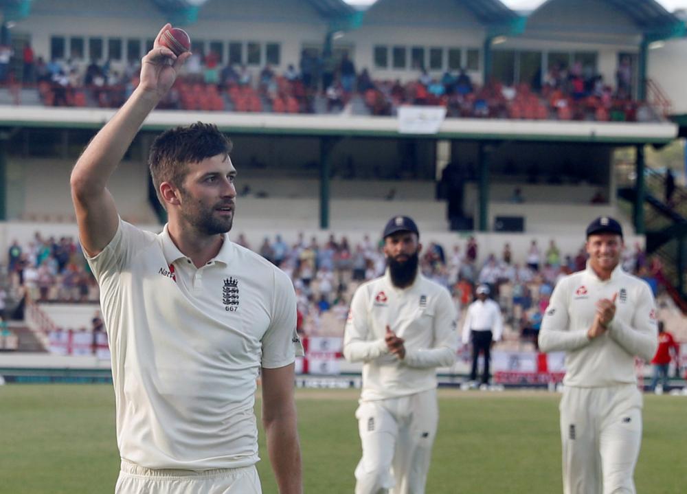 England’s Mark Wood celebrates with the ball during the third Test against West Indies at Darren Sammy National Cricket Stadium in St Lucia Sunday. — Reuters