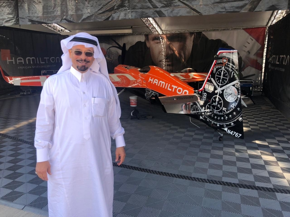 Abdullatif Mohammed Al-Ali Al-Abdullatif, CEO of Al-Ghazali Trade, which is the agent for Hamilton watches in Saudi Arabia, poses in front of one of the planes with Hamilton brand name emblazoned on the fuselage
