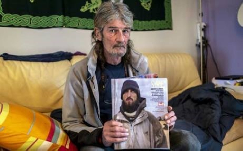 


Jacques Le Brun, whose son Quentin joined the Daesh group and has been caught by by Kurdish-led forces in Syria, holds up a copy of Paris Match featuring a picture of his son.

