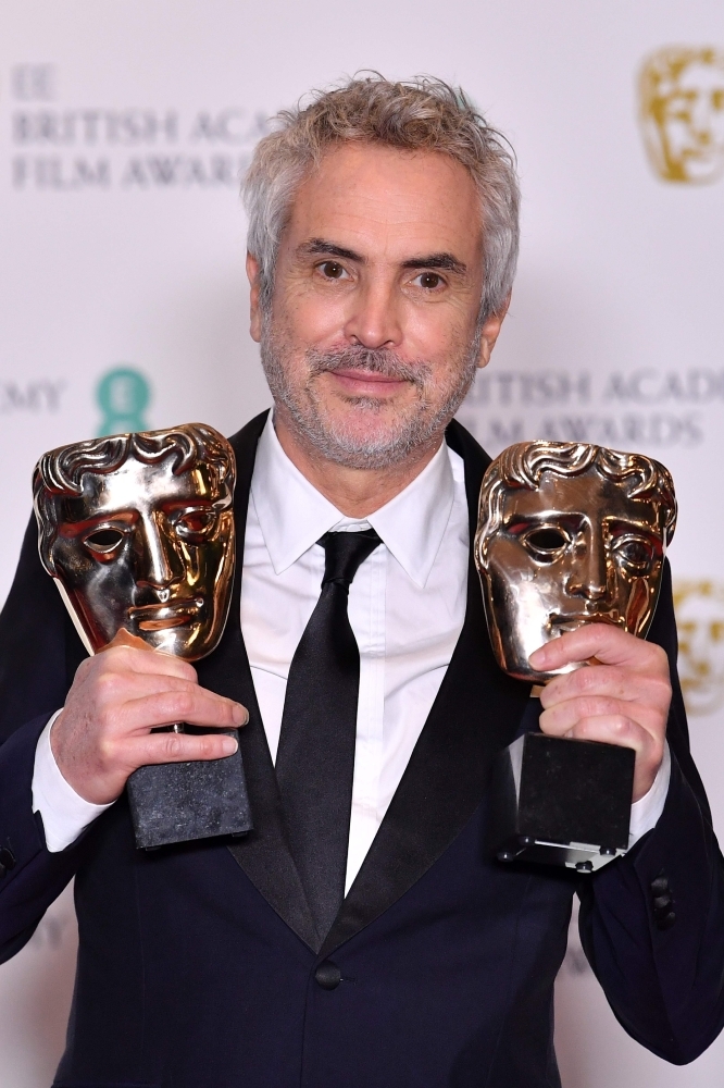 Mexican director Alfonso Cuaron poses with the awards for a Director and for Best Film for 'Roma' at the BAFTA British Academy Film Awards at the Royal Albert Hall in London. — Reuters
 
 / AFP / Ben STANSALL