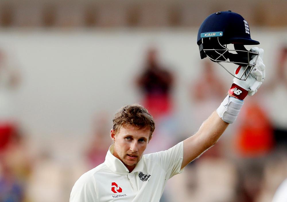 England’s Joe Root celebrates his century during their third cricket Test match against West Indies at Darren Sammy National Cricket Stadium in St Lucia Monday. — Reuters