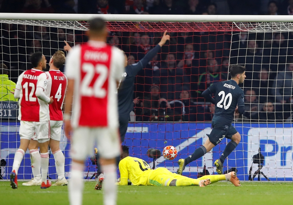 Real Madrid's Marco Asensio celebrates scoring their second goal against Ajax Amsterdam in the Champions League Round of 16 First Leg clash at the Johan Cruijff Arena, Amsterdam, Netherlands, on Wednesday. — Reuters 