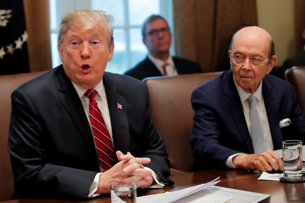 US President Donald Trump speaks next to Commerce Secretary Wilbur Ross during a Cabinet meeting at the White House in Washington, US, in this file photo. — Reuters