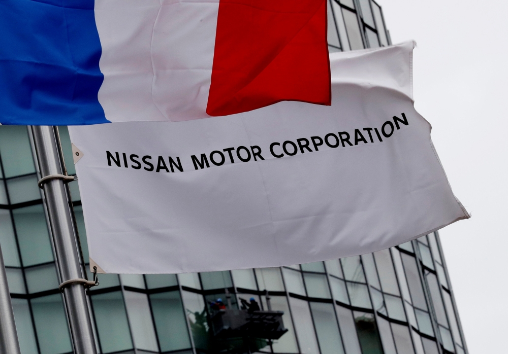Flags of France and Nissan are seen at the Nissan Motor Co.'s global headquarters in Yokohama, Japan, on Thursday. — Reuters
