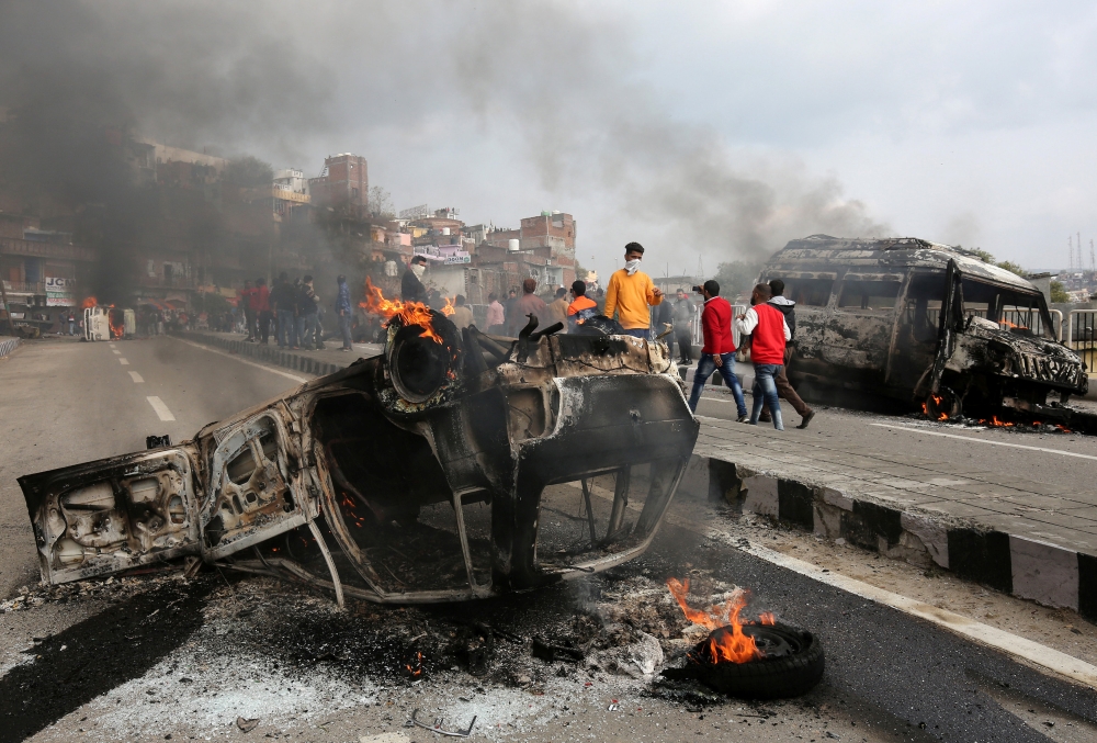 Vehicles set alight by demonstrators are pictured during a protest against the militant attack in Jammu on Friday. — Reuters