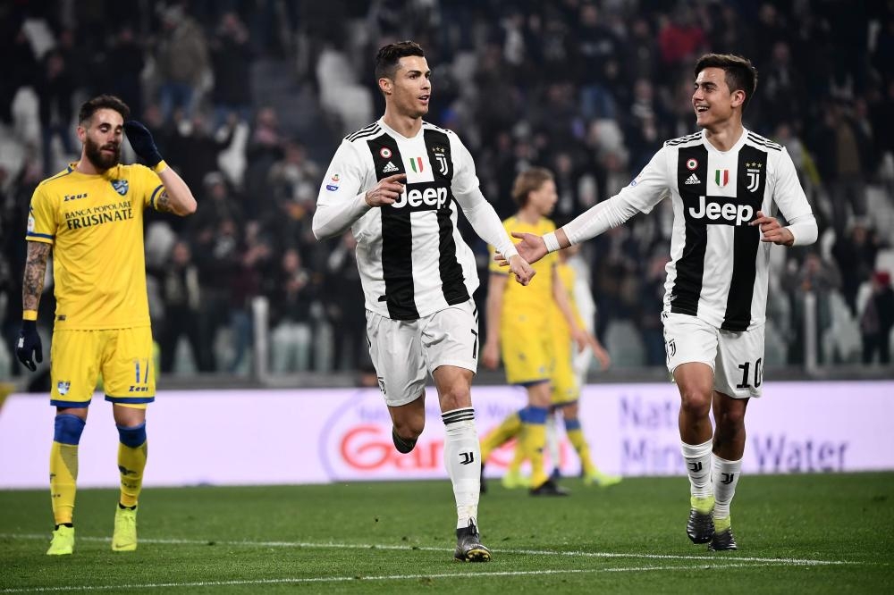 Juventus’ forward Cristiano Ronaldo (C) celebrates with temmate Paulo Dybala after scoring during the Italian Serie A football match against Frosinone at the Juventus Stadium in Turin Friday. — AFP