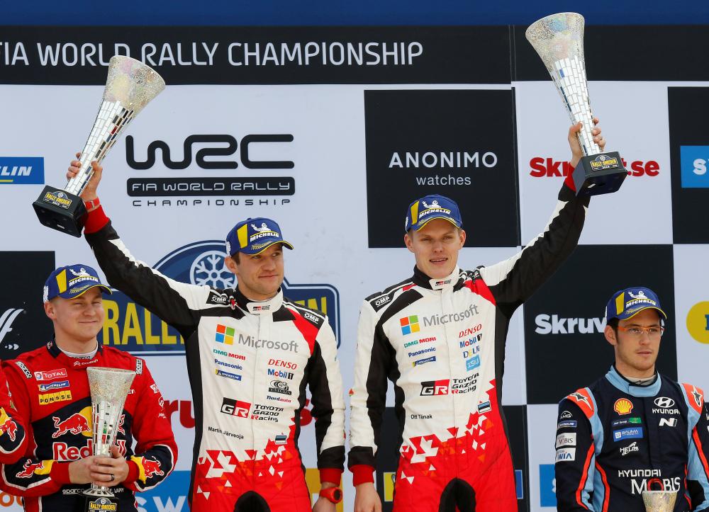 Estonian driver Ott Tanak (2nd R) and his co-driver Martin Jarveoja celebrate their victory in the Rally Sweden at Torsby, Sweden, Sunday. — Reuters