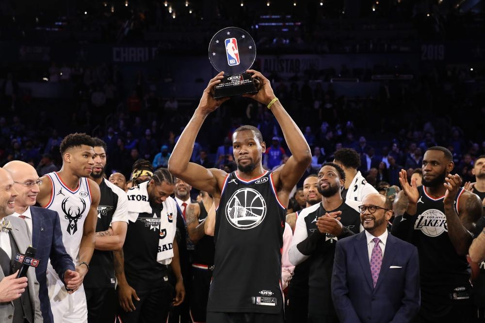 Kevin Durant of the Golden State Warriors and Team LeBron celebrates with the MVP trophy after their 178-164 win over Team Giannis during the NBA All-Star game as part of the 2019 NBA All-Star Weekend at Spectrum Center in Charlotte, North Carolina, Sunday. — AFP