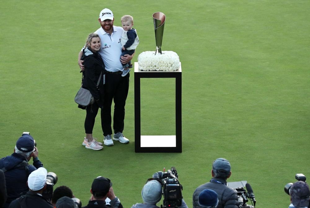 (L-R) Erica Holmes, J.B. Holmes and Tucker Holmes pose with the trophy after J.B. Holmes won the Genesis Open at Riviera Country Club in Pacific Palisades, California, Sunday. — AFP