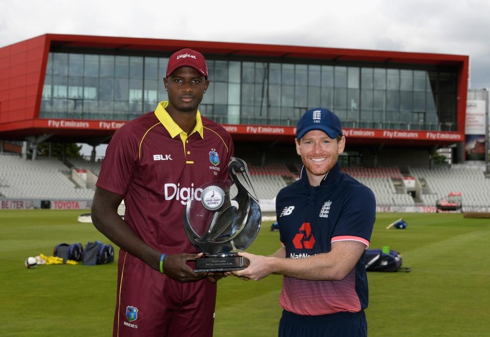 Jason Holder (L) and Eoin Morgan hold ODI Series Trophy. — AFP