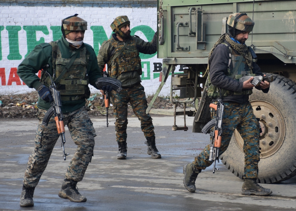 Indian Army soldiers arrive near the site of a gun battle between suspected militants and Indian security forces in Pinglan village in south Kashmir’s Pulwama district on Monday. — Reuters