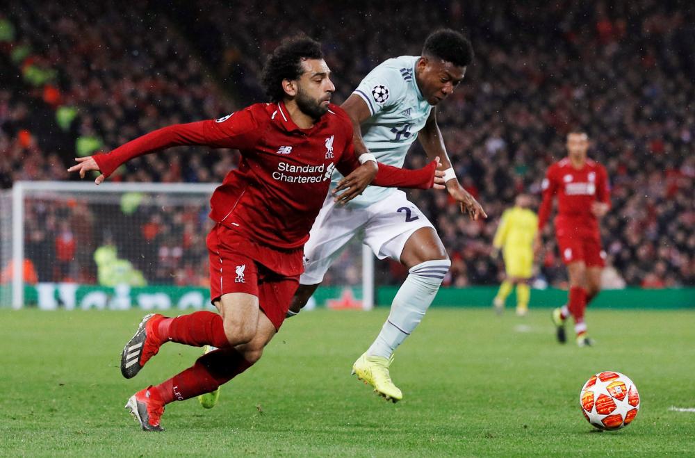 Liverpool’s Mohamed Salah (L) in action with Bayern Munich’s David Alaba during their Champions League Round of 16 first leg match at Anfield, Liverpool, Tuesday. — Reuters 