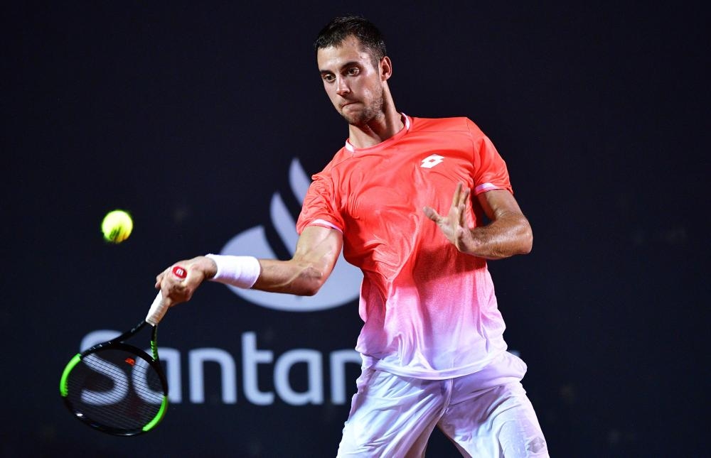 Serbia’s Laslo Djere returns a ball to Austria’s Dominic Thiem during their Rio Open match at the Jockey Club in Rio de Janeiro Tuesday. — AFP 