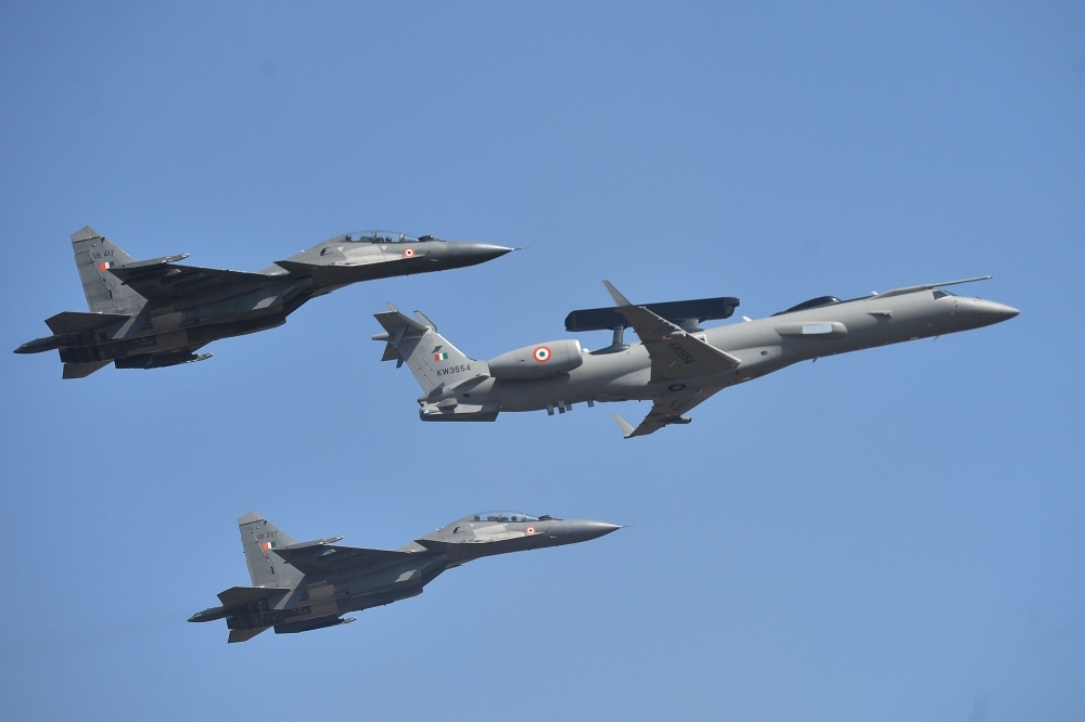 International delegates watch aircraft perform aerobatics during a flying display on the inaugural day of the five-day Aero India 2019 airshow at the Yelahanka Air Force station in Bangalore, India, on Wednesday. — AFP