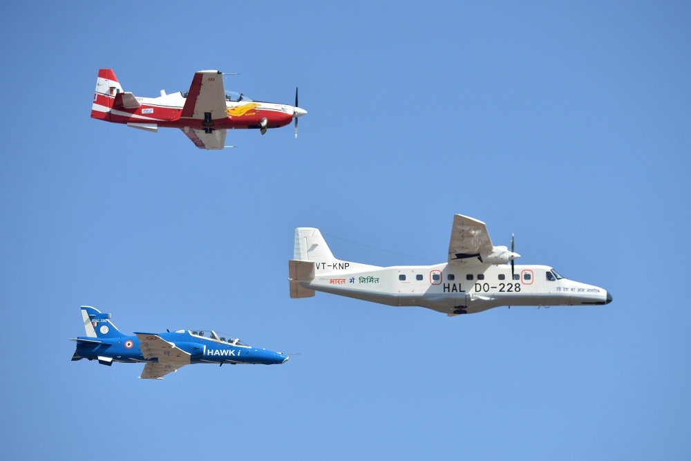 International delegates watch aircraft perform aerobatics during a flying display on the inaugural day of the five-day Aero India 2019 airshow at the Yelahanka Air Force station in Bangalore, India, on Wednesday. — AFP