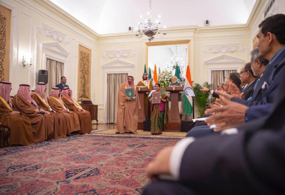 Crown Prince Muhammad Bin Salman, deputy premier and minister of defense, and Indian Prime Minister Narendra Modi supervise the signing of bilateral agreements as Minister of Energy, Industry and Mineral Resources Khalid Al-Falih and Indian Minister of External Affairs Sushma Swaraj exchange files at Hyderabad House in New Delhi on Wednesday. — SPA