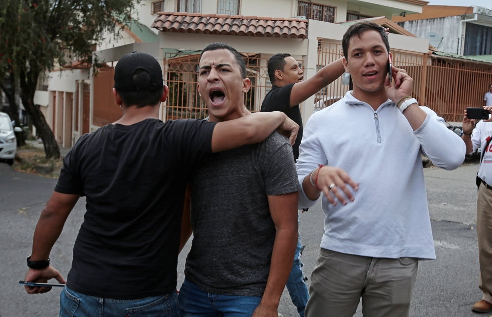 Venezuelan supporters of Venezuela’s opposition leader Juan Guaido argues with the supporters of Venezuela’s President Nicolas Maduro, after Guaido’s designated ambassador to Costa Rica Maria Faria took control of Venezuela’s embassy, in San Jose, Costa Rica, on Wednesday. — Reuters