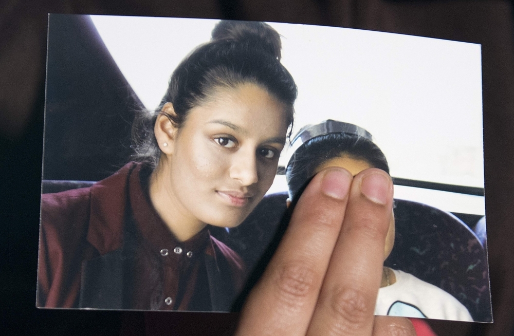 Renu Begum, eldest sister of missing British girl Shamima Begum, holds a picture of her sister while being interviewed by the media in central London in this Feb. 22, 2015 file photo. — AFP