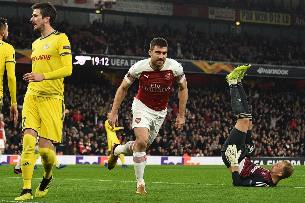 Arsenal's Greek defender Sokratis Papastathopoulos (C) celebrates after scoring their third goal during the UEFA Europa League round of 32, 2nd leg football match between Arsenal and Bate Borisov at the Emirates stadium in London on Thursday. — AFP