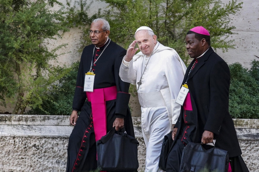 Pope Francis waves as he arrives on the second day of a global child protection summit for reflections on the sex abuse crisis within the Catholic Church at the Vatican on Friday. — AFP