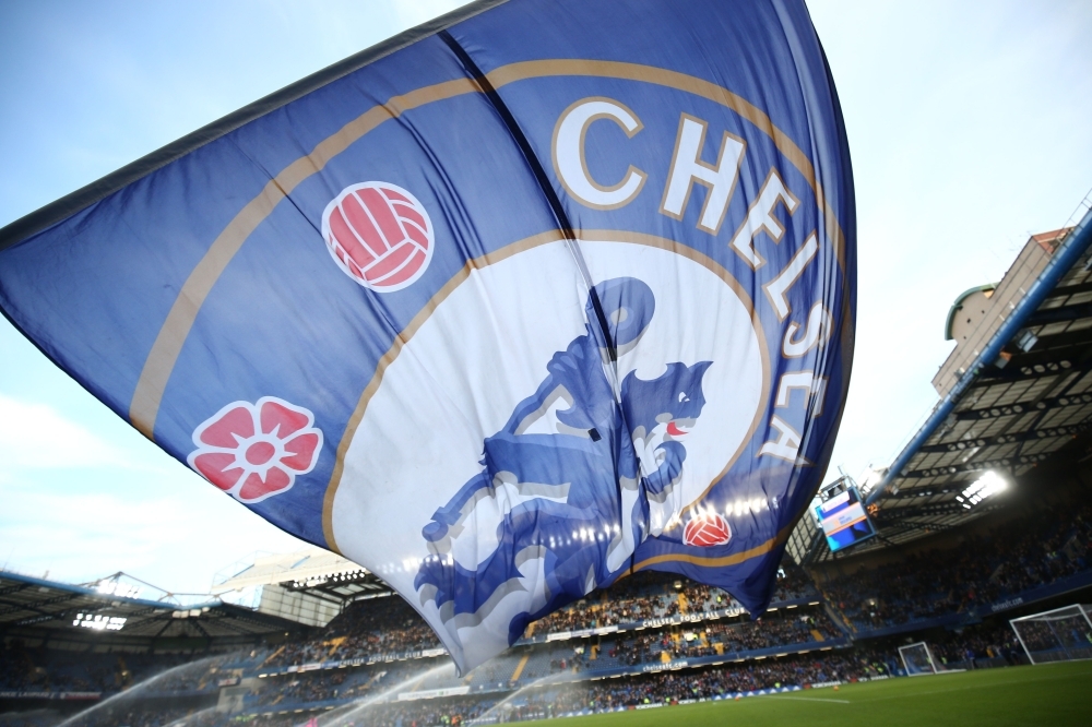 In this file photo a giant Chelsea flag flies before kick off of the English Premier League football match between Chelsea and Everton at Stamford Bridge in London.  Premier League club Chelsea have been banned from signing new players in the next two transfer windows as punishment for breaking rules on registering underage players, FIFA said on Friday. — AFP