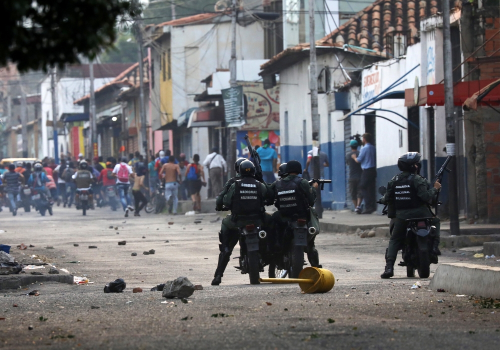 Venezuelan activists clash with security forces in Urena, Saturday. — Reuters