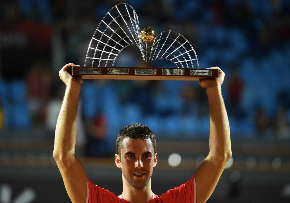 Serbia’s Laslo Djere poses with the trophy after beating Canada’s Felix Auger-Aliassime in the ATP World Tour Rio Open at the Jockey Club in Rio de Janeiro Sunday. — AFP 