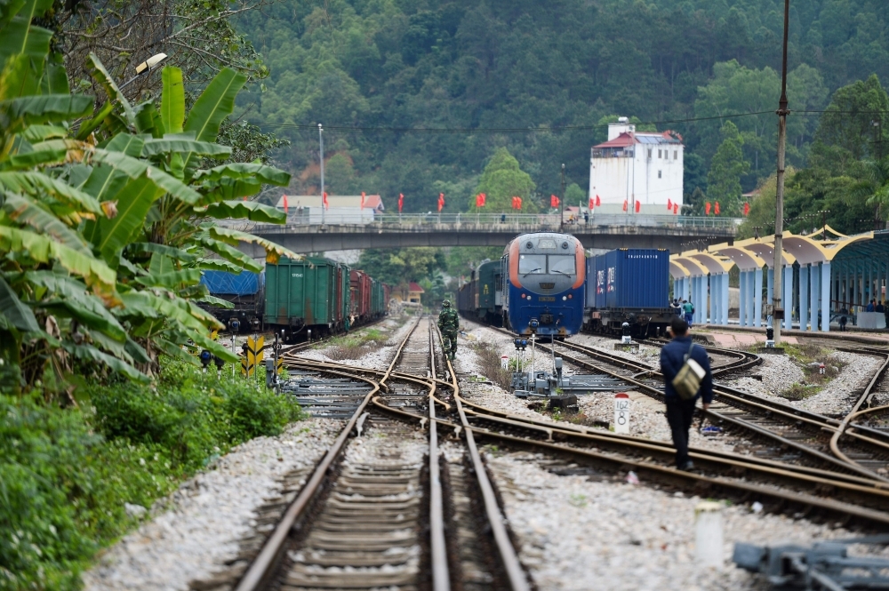 A Vietnamese soldier, center, and a man inspect the track near the Dong Dang railway station, where North Korean leader Kim Jong Un is expected to arrive by train ahead of the second US-North Korea summit, in Lang Son on Monday. — AFP