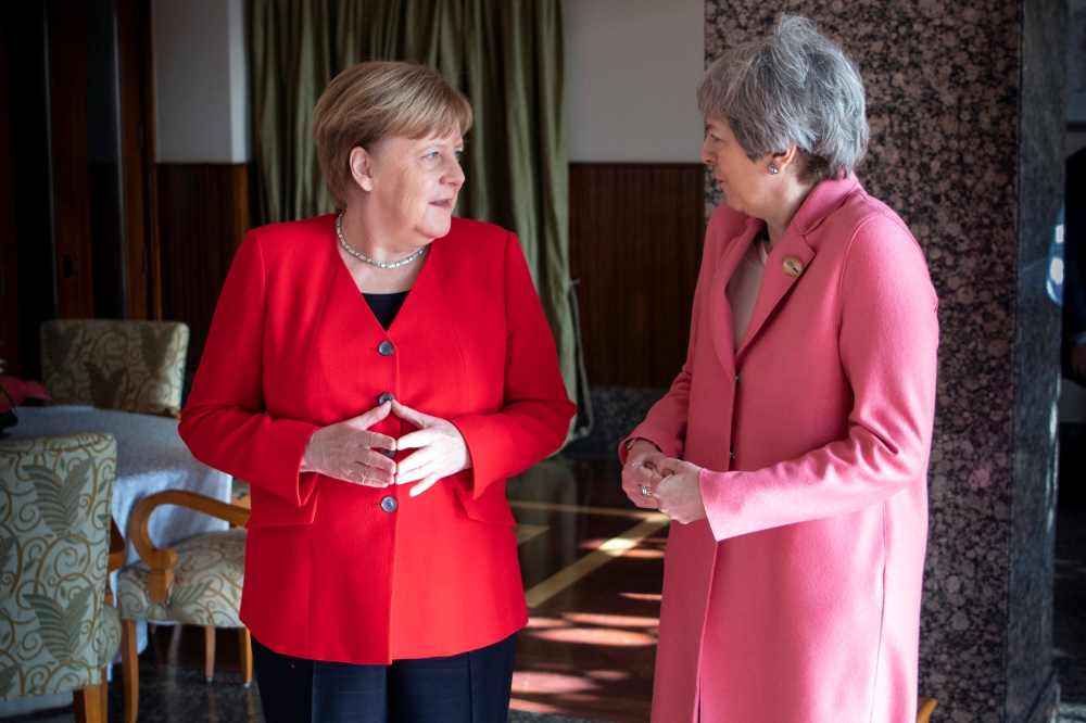 German Chancellor Angela Merkel meets Britain’s Prime Minister Theresa May during the first EU-Arab League Summit in Sharm El-Sheikh, Egypt, on Monday. — Reuters