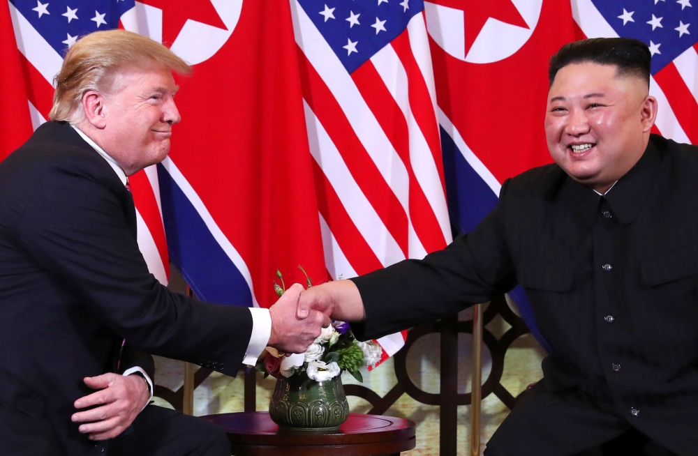US President Donald Trump and North Korean leader Kim Jong Un shake hands before their one-on-one chat during the second US-North Korea summit at the Metropole Hotel in Hanoi, Vietnam, on Wednesday. — Reuters
